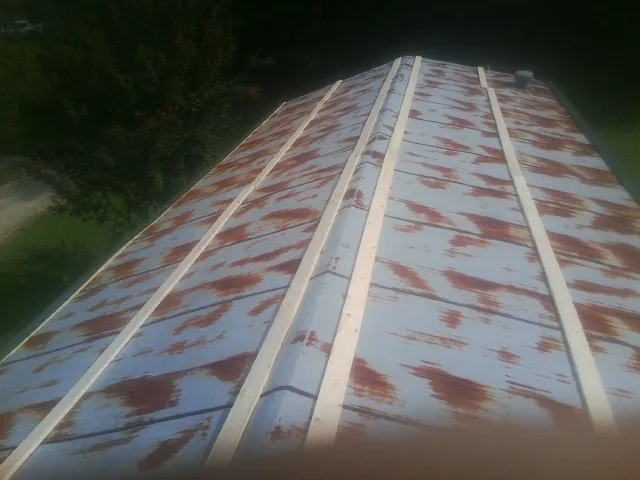 Rusted metal roof panels with new wood purlins before replacement — Storm Damage Roof Repair in Boonville by Roofing Brothers